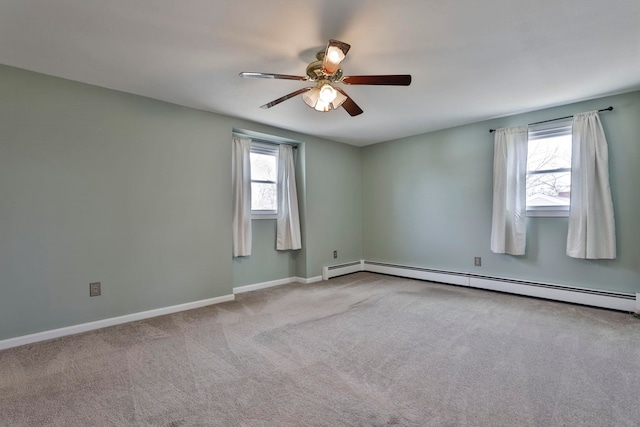 carpeted empty room featuring baseboard heating, a ceiling fan, and baseboards