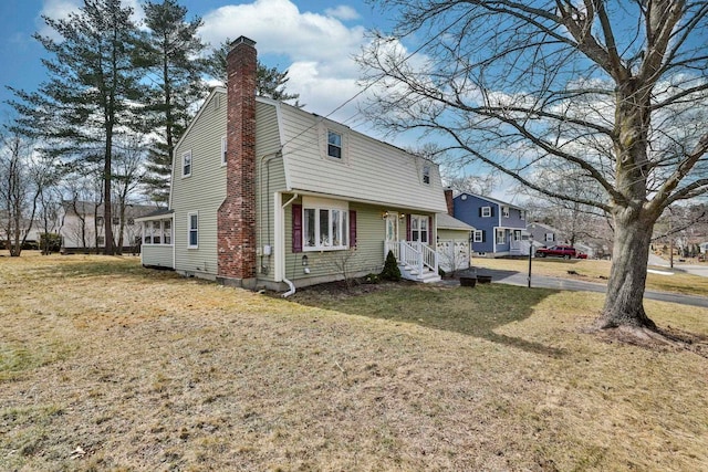 view of front of home with a front yard and a chimney