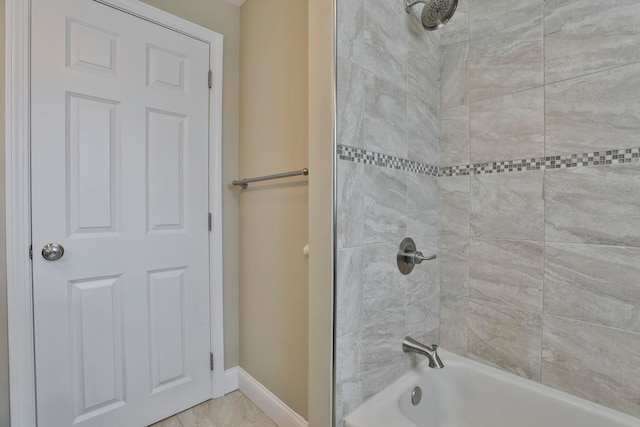 bathroom featuring shower / bath combination and baseboards