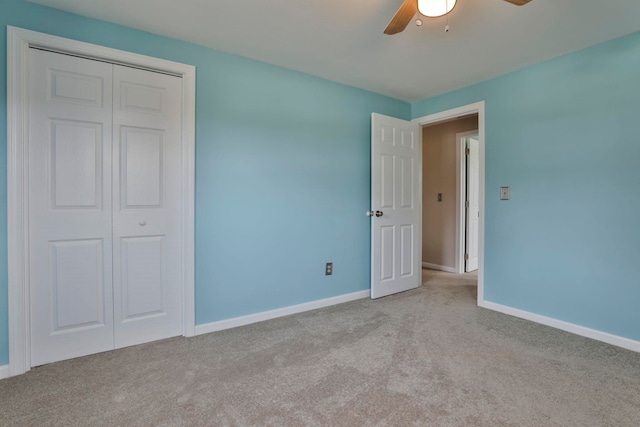 unfurnished bedroom with a closet, ceiling fan, baseboards, and carpet