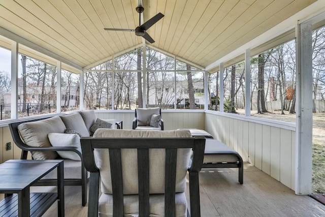 sunroom with lofted ceiling, wood ceiling, and a ceiling fan