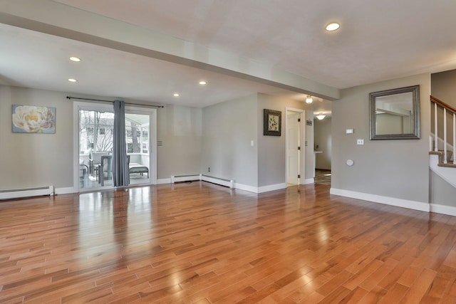 unfurnished room with recessed lighting, light wood-style flooring, stairs, and a baseboard radiator