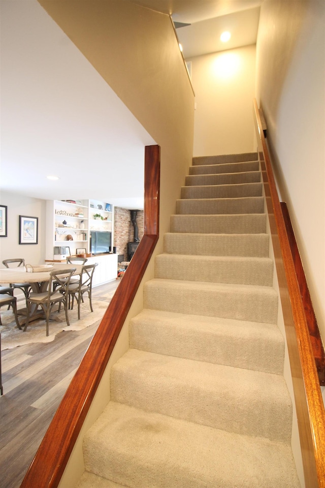 stairs featuring recessed lighting and wood finished floors