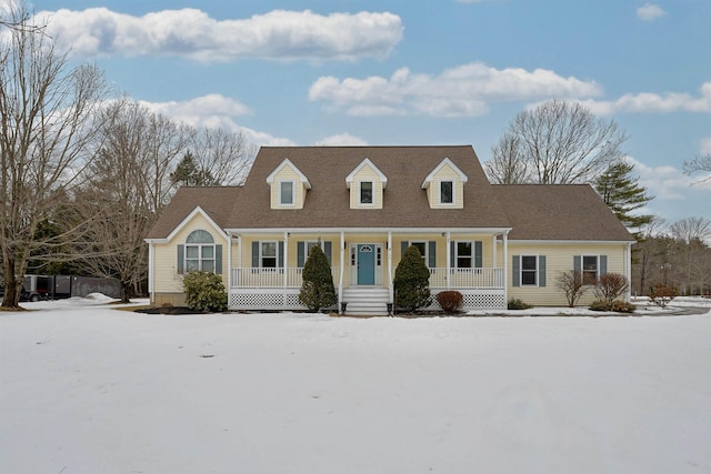 cape cod-style house with covered porch and roof with shingles