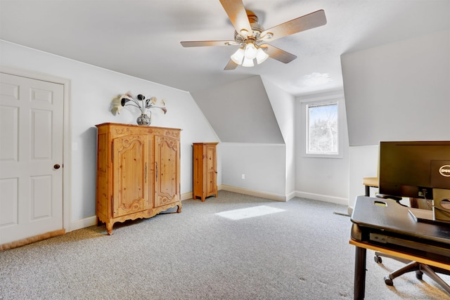 home office featuring light colored carpet, baseboards, lofted ceiling, and a ceiling fan