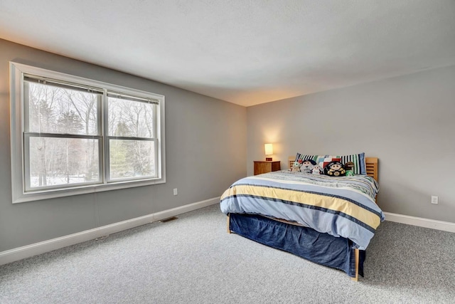 bedroom with visible vents, baseboards, and carpet floors