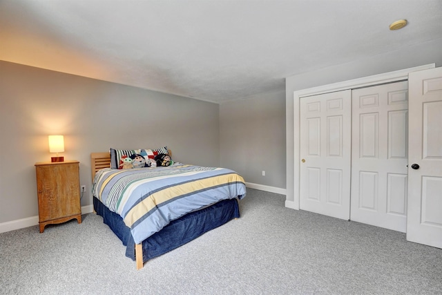 bedroom with a closet, baseboards, and carpet