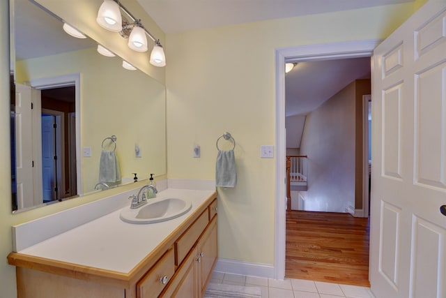 bathroom with vanity, tile patterned floors, and baseboards