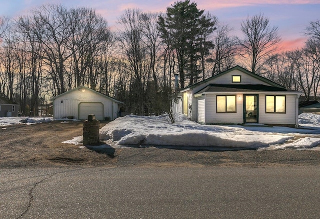 view of front facade with an outbuilding, driveway, and a garage