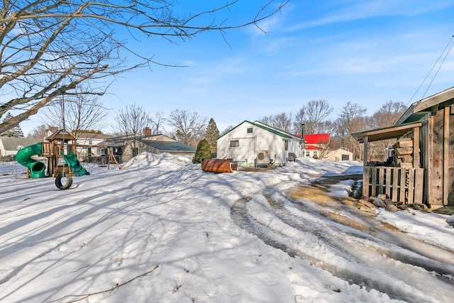 yard layered in snow with a playground