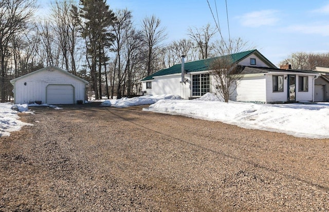 view of front of house with a detached garage and an outdoor structure