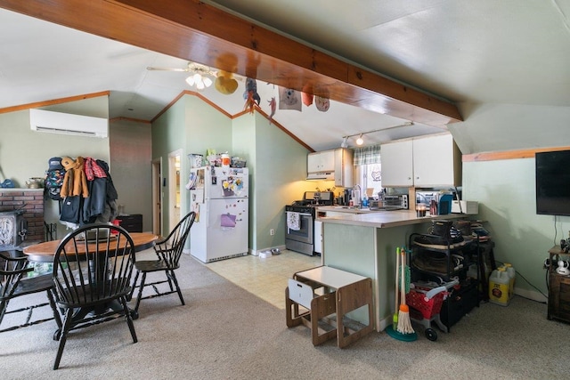 kitchen featuring lofted ceiling with beams, stainless steel gas range, freestanding refrigerator, white cabinetry, and a wall mounted AC