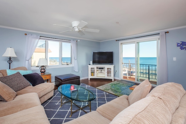 living area featuring ceiling fan, baseboards, wood finished floors, and crown molding