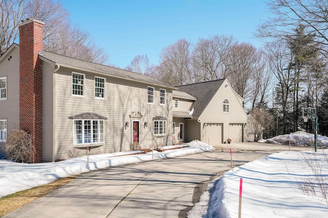 view of front of house with driveway and a chimney