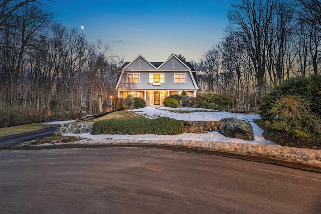 shingle-style home featuring aphalt driveway and a gambrel roof