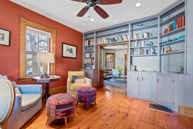 sitting room featuring visible vents, built in shelves, ceiling fan, recessed lighting, and light wood-style floors