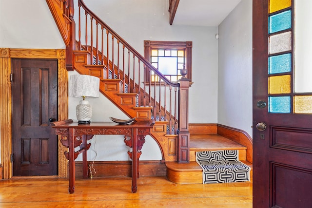 entryway featuring wood finished floors and stairs