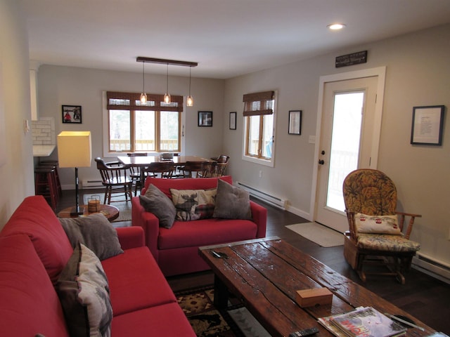 living room with a wealth of natural light, baseboards, baseboard heating, and recessed lighting