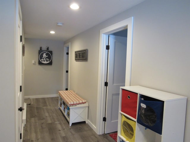 hall featuring recessed lighting, baseboards, and wood finished floors