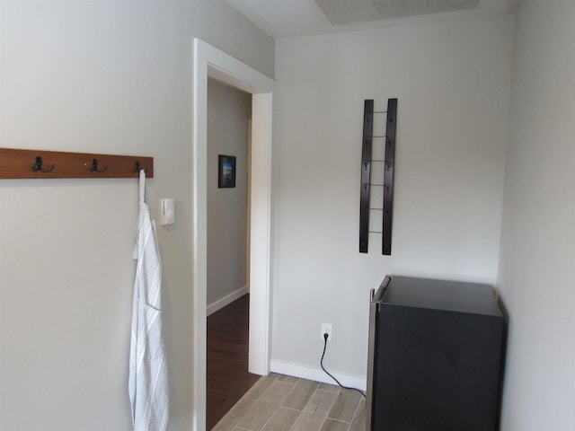 interior space with baseboards and wood finished floors