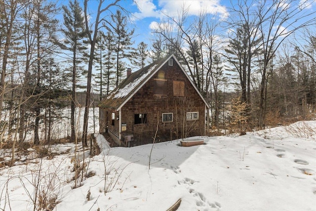 snow covered property featuring a chimney