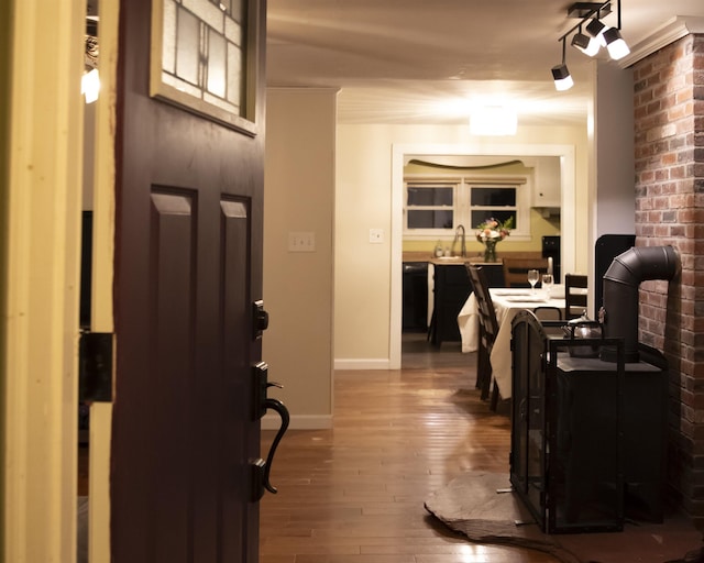 interior space with dark wood-style floors, baseboards, and a sink