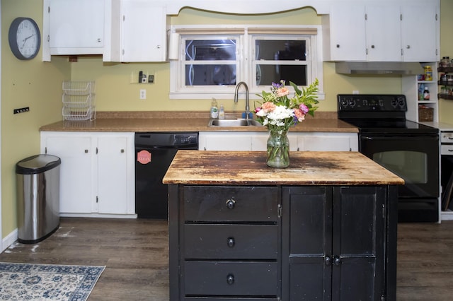 kitchen featuring dark wood finished floors, a sink, black appliances, white cabinets, and under cabinet range hood