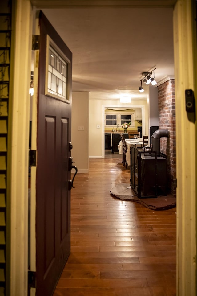 interior space featuring baseboards, track lighting, and hardwood / wood-style flooring