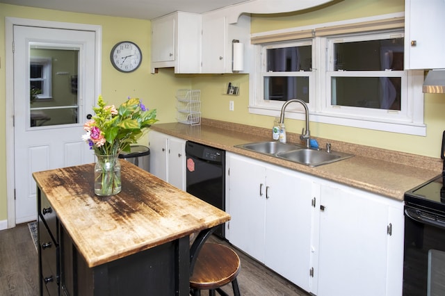 kitchen with a kitchen island, dark wood finished floors, a sink, black appliances, and white cabinets