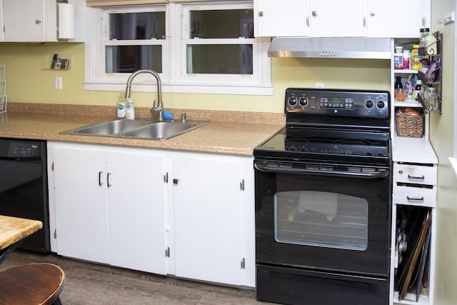 kitchen featuring black appliances, a sink, under cabinet range hood, wood finished floors, and white cabinets