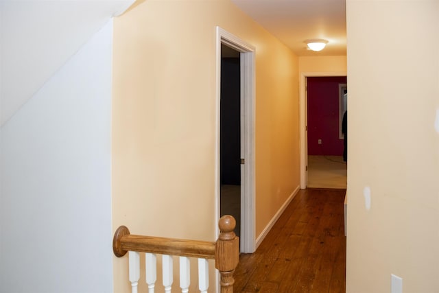 hall with hardwood / wood-style flooring and baseboards