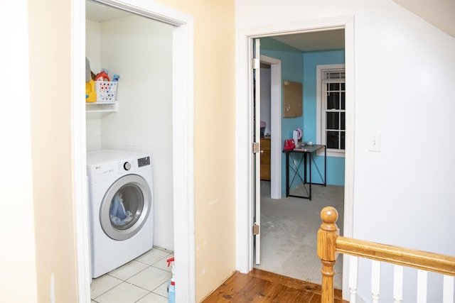 laundry area featuring tile patterned flooring, laundry area, and washer / dryer