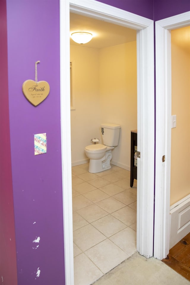 bathroom featuring tile patterned flooring, a bidet, and baseboards