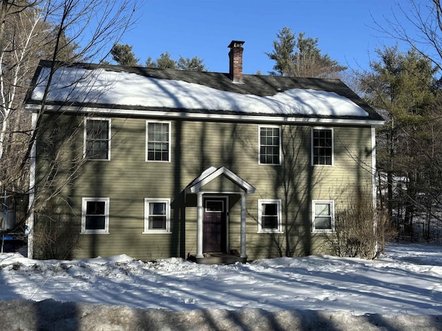 colonial home featuring a chimney