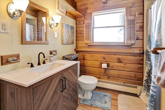 bathroom featuring toilet, a baseboard heating unit, wood finished floors, a shower with shower curtain, and vanity