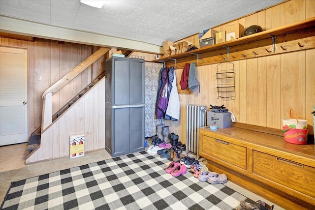 interior space with wood walls and radiator