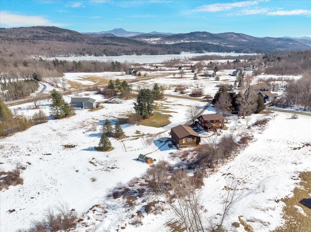 snowy aerial view featuring a mountain view