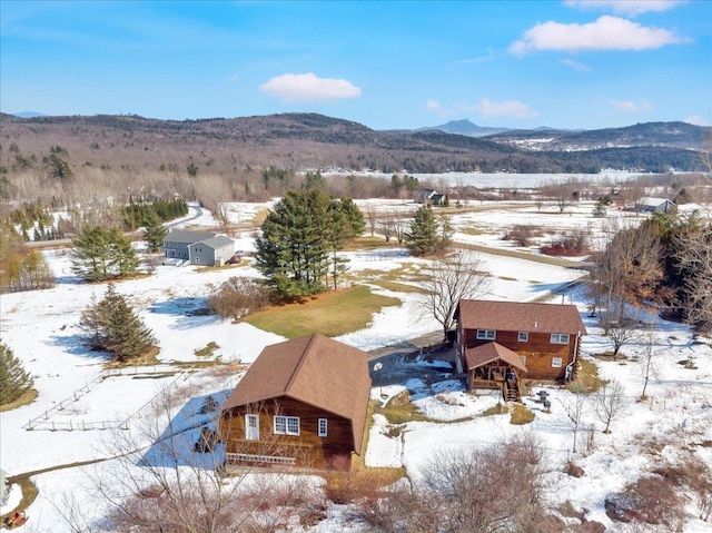 snowy aerial view with a mountain view