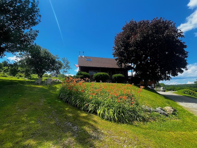 view of side of property featuring a lawn