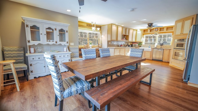 dining space featuring ceiling fan with notable chandelier, recessed lighting, and light wood-style floors