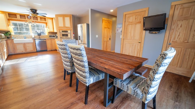 dining space with recessed lighting, light wood-type flooring, ceiling fan, and a toaster