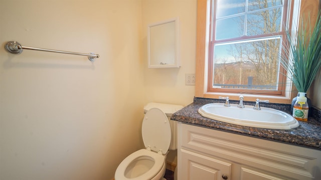 half bathroom with toilet and vanity