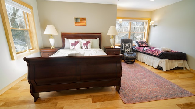 bedroom featuring baseboards and light wood-style floors