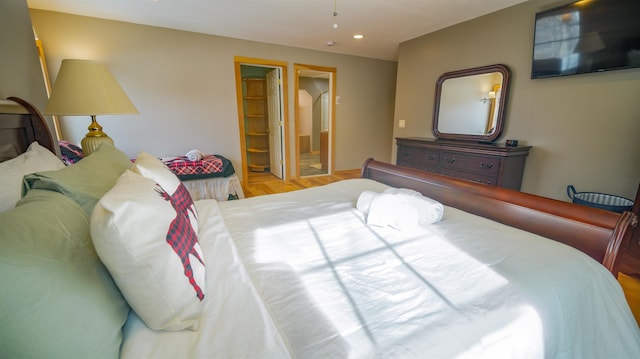 bedroom featuring ensuite bath and recessed lighting