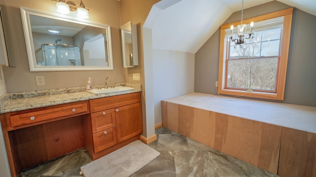 full bathroom with vanity, vaulted ceiling, a notable chandelier, and walk in shower