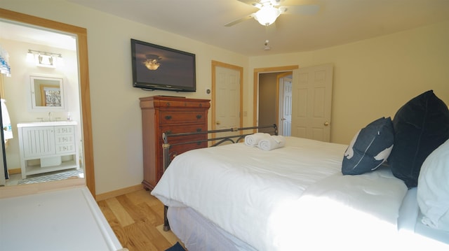 bedroom featuring connected bathroom, a ceiling fan, light wood-type flooring, and baseboards