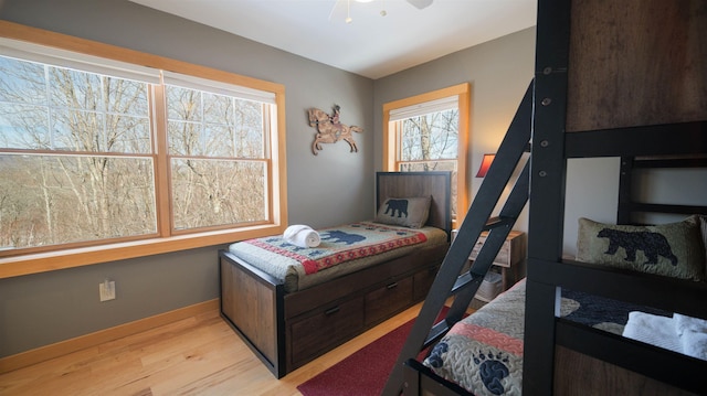 bedroom featuring light wood-style floors and baseboards