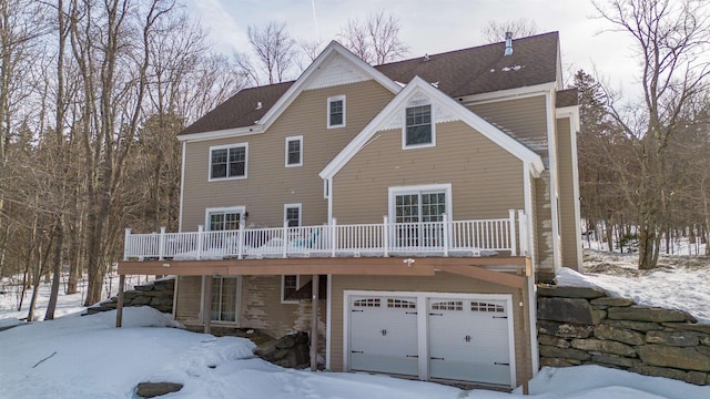 snow covered house with a wooden deck and stairs