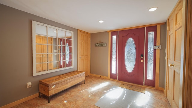 foyer entrance with recessed lighting and baseboards