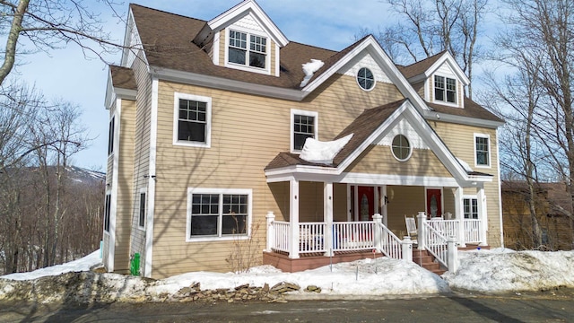 view of front facade featuring a porch and a shingled roof